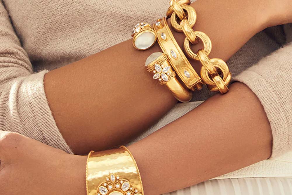 arms crossed wearing gold bracelets