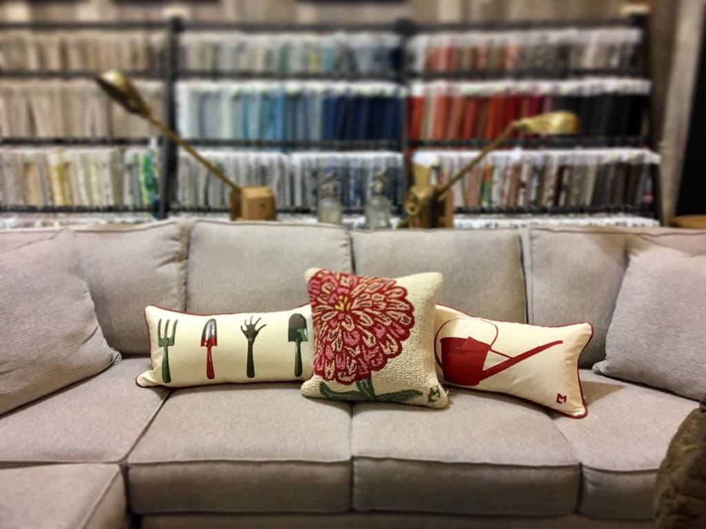 couch and pillows with surroundf abric swatches