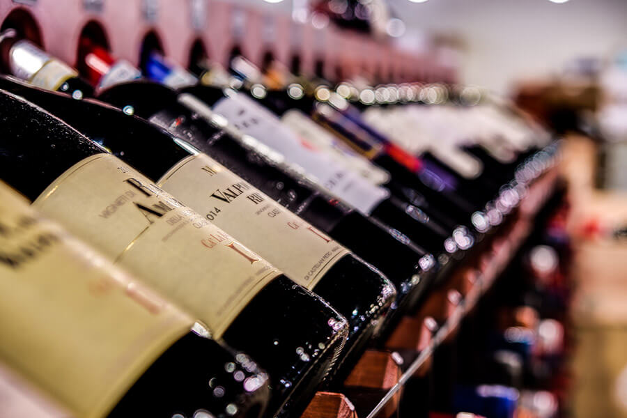 close shot of wine bottles lying on racks